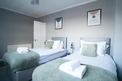 a bedroom with two beds with towels on them at Darmeid House in Hartwood