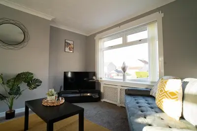 a living room with a couch and a window at Darmeid House in Hartwood