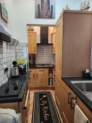 a small kitchen with a sink and a counter top at Largs holiday flat in Largs