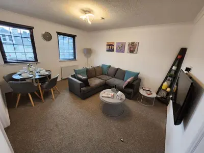 a living room with a couch and a table at 10 Ladyknowe court in Moffat