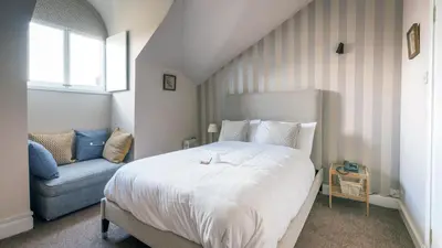 a bedroom with a large bed and a couch at The Belhaven Hotel in Glasgow