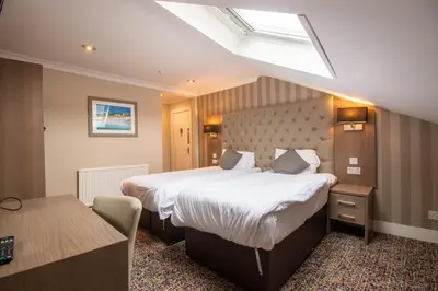 a hotel room with a large bed and a desk at Albion Hotel in Glasgow
