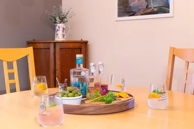 a wooden table with a tray of drinks and wine glasses at The Jaw Barn in Milngavie