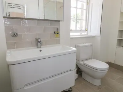 a bathroom with a white sink and a toilet at 6 Kirkstyle in Biggar