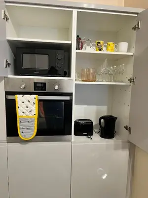 a kitchen with a microwave and a stove at CAMPBELL 100 DUNFERMLINE in Fife