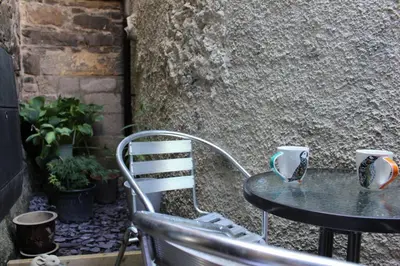 a table with two coffee mugs on top of it at Cameronian Apartment in Stirling