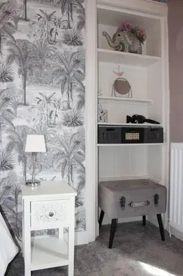 a room with a table and a wall with palm trees at Cameronian Apartment in Stirling