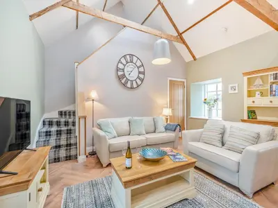 a living room with a couch and a table at The Byre - Uk45343 in Ayr