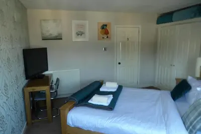 a bedroom with a bed with a tv and a bedskirtspectspectspectspects at Aigas in Glasgow
