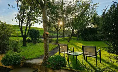 two chairs and a table in a park at Ash Cottage in Stranraer