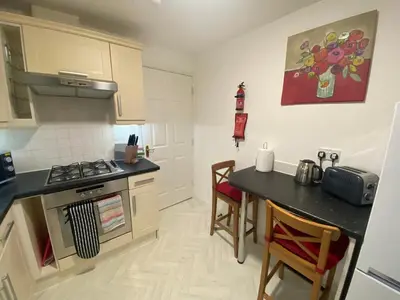 a kitchen with a counter and a stove top oven at Prime Duloch Bridge View by TBA in Dunfermline