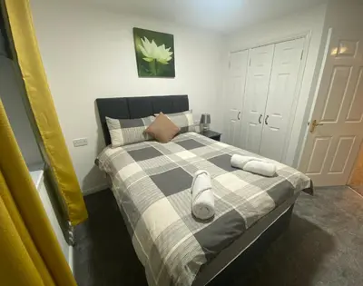 a bedroom with a bed with two towels on it at Prime Duloch Bridge View by TBA in Dunfermline
