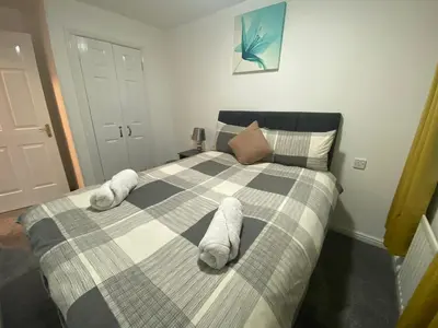 a bedroom with a bed with white towels on it at Prime Duloch Bridge View by TBA in Dunfermline