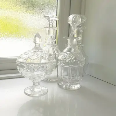 three clear glass vases sitting on a window sill at Peaceful and Stunning Waterside Location in Helensburgh