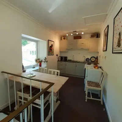 a kitchen with a table and a counter top at Peaceful and Stunning Waterside Location in Helensburgh