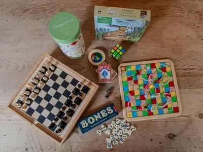a table with a chess game and a box of dominoes at Stable Cottage, Gartocharn, Loch Lomond in Alexandria