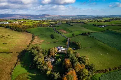 an aerial view of a house in a field at Stable Cottage, Gartocharn, Loch Lomond in Alexandria