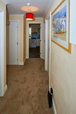 a hallway of a home with a painting on the wall at Little Bay View in Oban