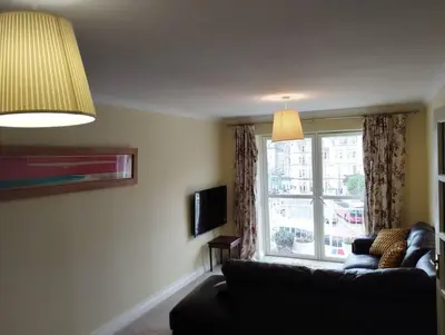 a living room with a couch and a window at Little Bay View in Oban