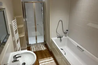 a bathroom with a shower and a sink and a tub at The Heathers in Killin