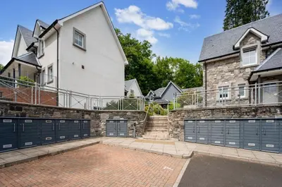 a house with two garage gates in front of it at The Heathers in Killin