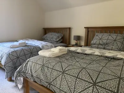 two beds sitting next to each other in a bedroom at The Heathers in Killin