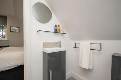a bathroom with a sink and a mirror at Historical Holmehill Lodge in Dunblane