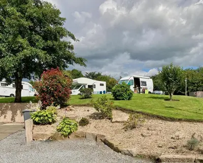 a campsite with two rvs in a park at Red Deer Village Holiday Park - 3 Bedroom, Self-Catering Holiday Home in Steps