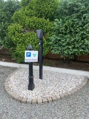 a parking meter with a sign on top of gravel at Red Deer Village Holiday Park - 3 Bedroom, Self-Catering Holiday Home in Steps