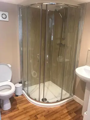 a shower stall in a bathroom with a toilet at Red Deer Village Holiday Park - 3 Bedroom, Self-Catering Holiday Home in Steps