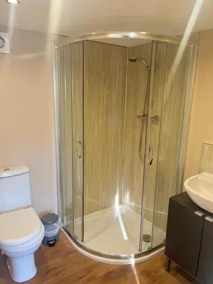 a shower in a bathroom with a toilet and a sink at Red Deer Village Holiday Park - 2 Bedroom, Self-Catering Chalet in Steps