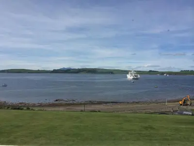 a boat in a large body of water at Broom Lodge in Largs