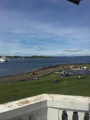 a view of a body of water with a field of grass at Broom Lodge in Largs