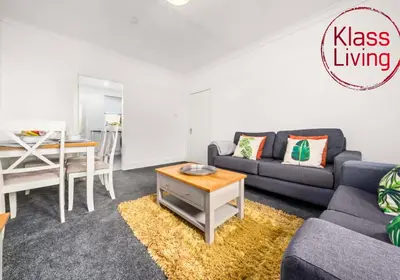 a living room with a couch and a table at Broomfield Apartment by Klass Living Airdrie in Airdrie