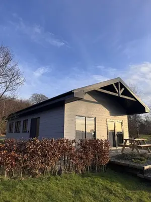 a house with a gambrel roof on the side of it at Spacious 3-Bedroom Chalet on Country Estate near Glasgow - sleeps 6 in Glasgow