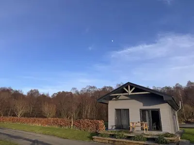 a small white house with a black roof at Spacious 3-Bedroom Chalet on Country Estate near Glasgow - sleeps 6 in Glasgow