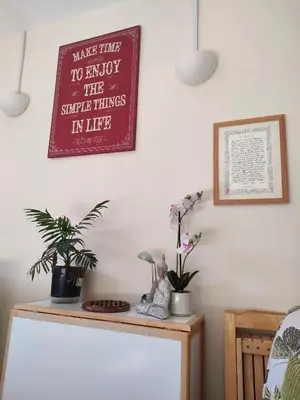 a sign on a wall above a table with plants at Forth Road Bridge Views in Queensferry