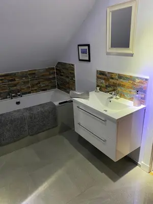 a bathroom with a sink and a bath tub at Woodhead view in Kirkintilloch