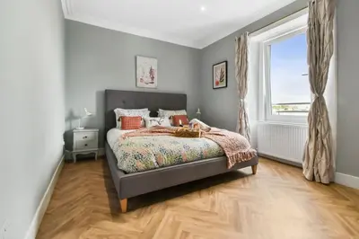 a bedroom with a bed and a window at Seaside Place, Aberdour in Aberdour