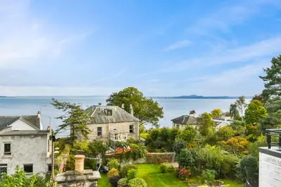 an aerial view of a house with the ocean in the background at Seaside Place, Aberdour in Aberdour