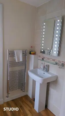 a bathroom with a sink and a mirror at Edinburgh City Suites in Edinburgh