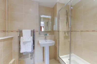 a bathroom with a sink and a shower at Edinburgh City Suites in Edinburgh