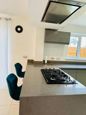 a kitchen with a counter with a stove top at 5 Bedroom detached House near Edinburgh Airport, City center and Murrayfield Stadium in East Calder