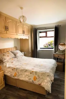 a bedroom with a bed and a window at Sea View Farmhouse in Cushendun