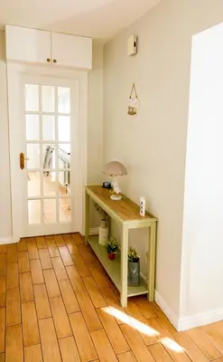 a room with a table with a lamp and a door at Sea View Farmhouse in Cushendun