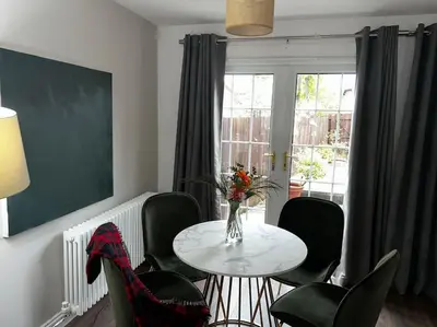 a room with a table and chairs and a window at 15 min drive to airport 20 min to Loch Lomond and city center in Old Kilpatrick