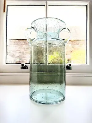 a glass vase sitting on a table with a window at Luxury Smugglers Cottage in the Heart of Inveraray Sleeps 4 in 2 Bedrooms in Inveraray