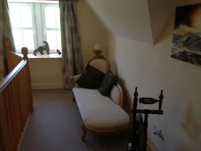 a living room with a chair and a window at Langside in Stirling