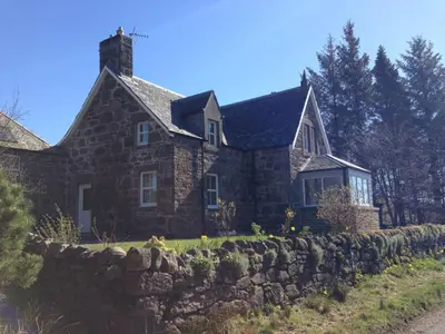 a stone house with a stone wall at Langside in Stirling