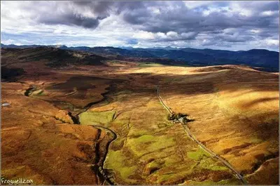 an aerial view of a field with a dirt road at Langside in Stirling